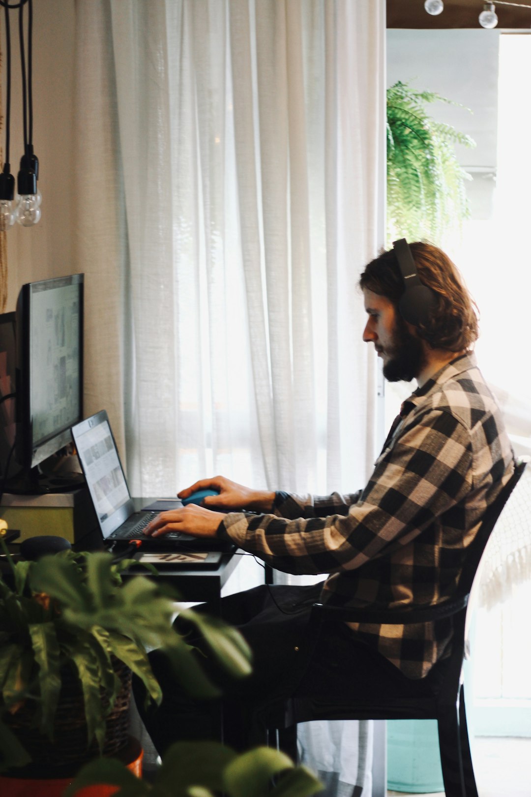 woman in black and white plaid dress shirt using laptop computer person working from home, laptop healthcare coding, home office workspace, relaxed professional