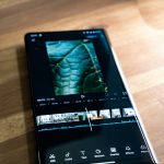 a black cell phone overlay clip split tool, CapCut timeline, spliced video layers