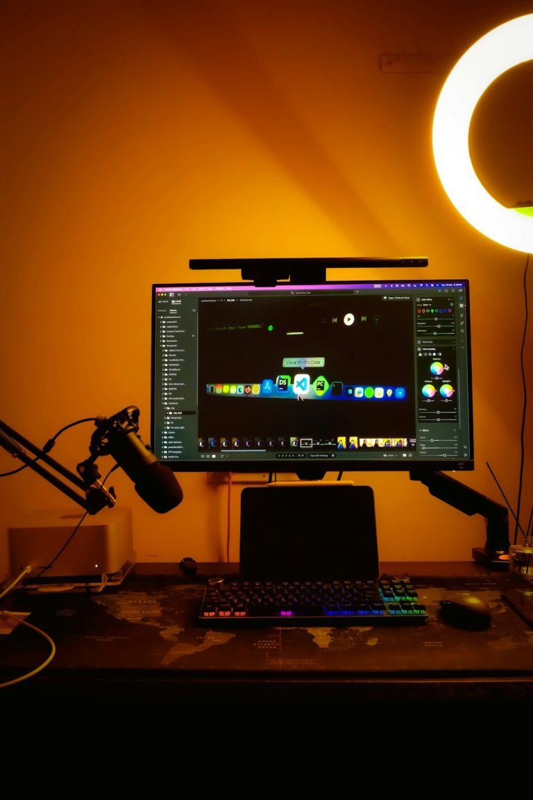 a computer monitor sitting on top of a desk live streaming gamer setup, colorful LED lights, streaming microphone and monitor
