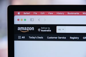 a computer screen with the amazon logo on it person laptop amazon boxes checklist