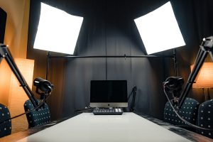 a desk with a laptop and microphones professional streaming studio, camera microphone lighting, control desk, live broadcast environment
