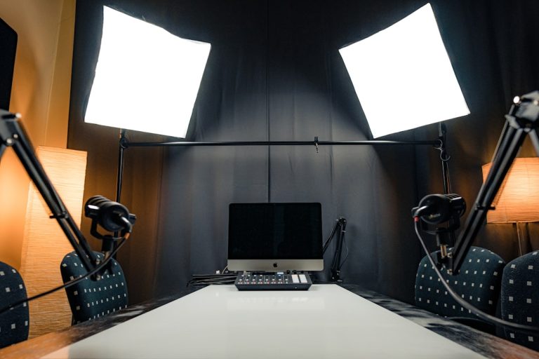 a desk with a laptop and microphones professional streaming studio, camera microphone lighting, control desk, live broadcast environment