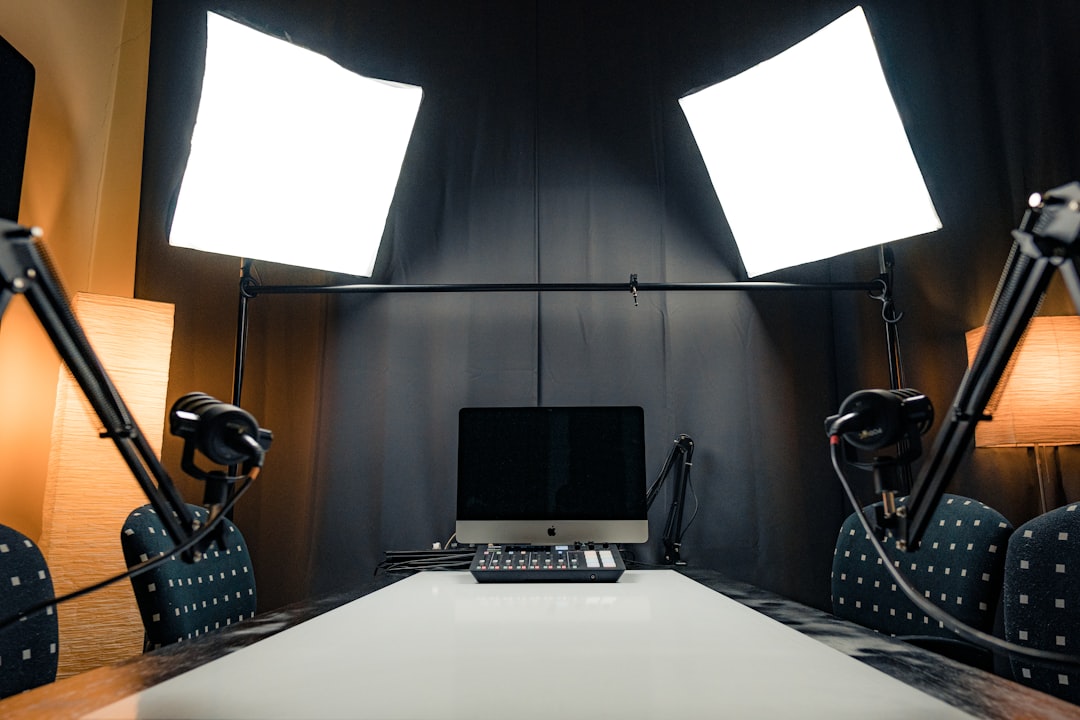 a desk with a laptop and microphones professional streaming studio, camera microphone lighting, control desk, live broadcast environment