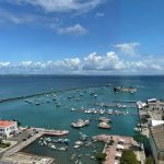 a harbor filled with lots of boats under a blue sky before after photo comparison, image upscaling example, low resolution vs high resolution