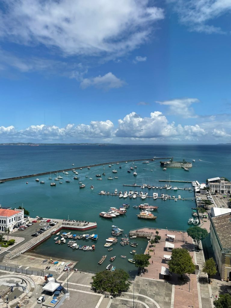 a harbor filled with lots of boats under a blue sky before after photo comparison, image upscaling example, low resolution vs high resolution