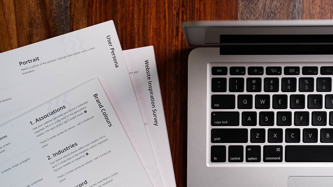 a laptop computer sitting on top of a wooden table job interview, resume review, recruiter, candidate