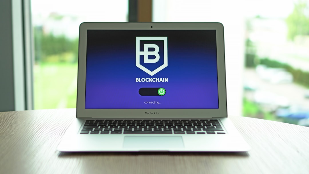a laptop computer sitting on top of a wooden table laptop login screen with two factor authentication prompt, shield icon, secure account concept