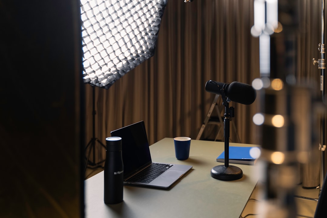 a laptop on a table professional streaming studio, camera microphone lighting, control desk, live broadcast environment