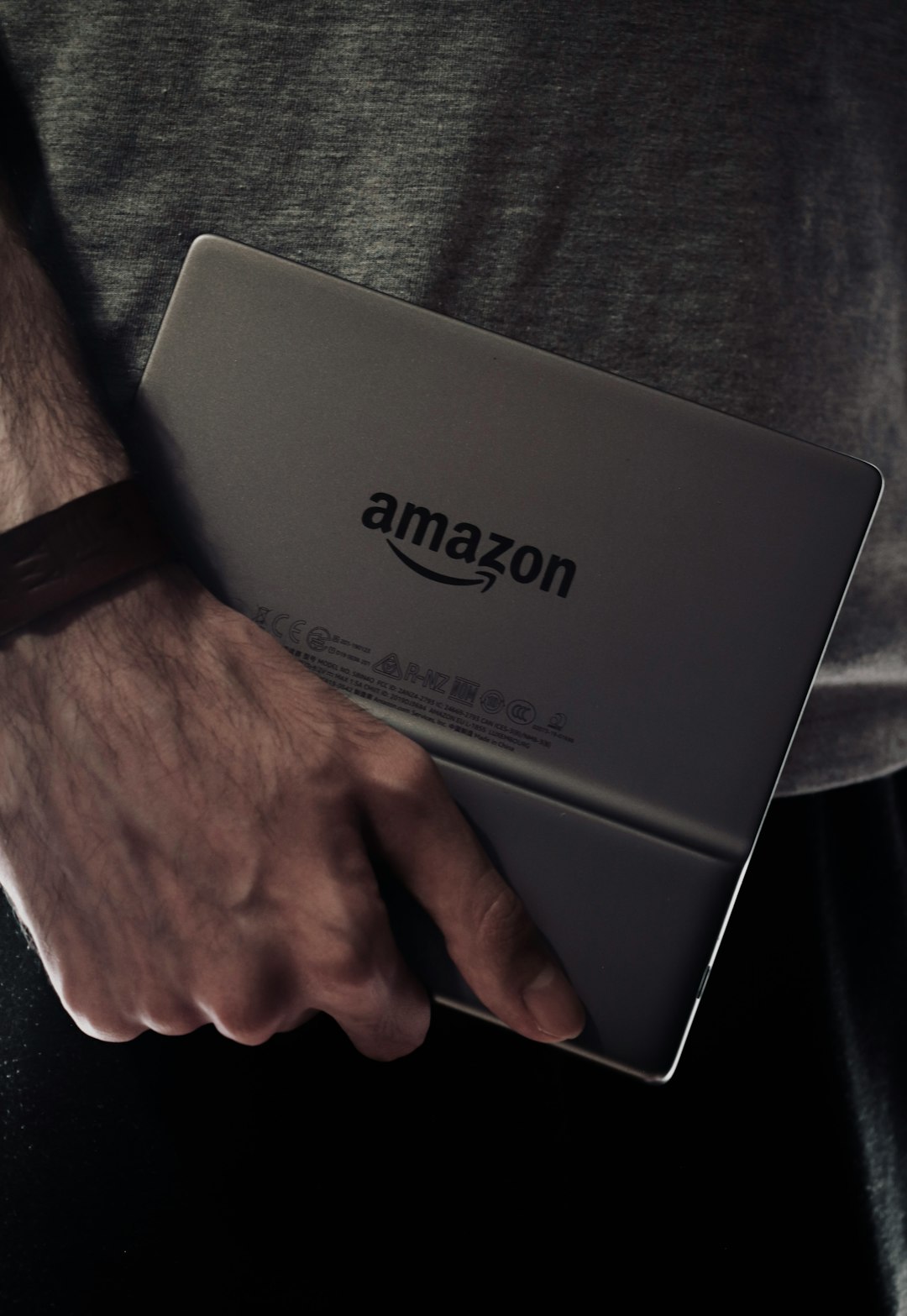 a man holding a laptop computer in his hands person laptop amazon boxes checklist