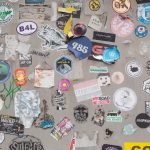 A wall covered in lots of different types of stickers custom stickers, product packaging, brand labels