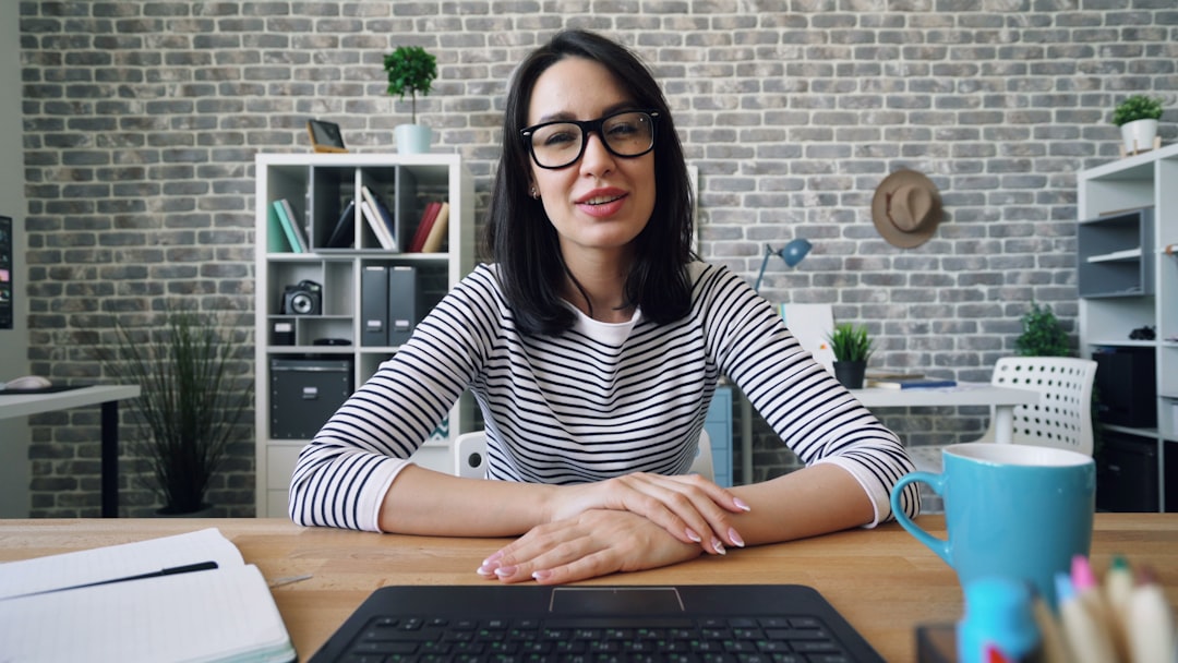 a woman sitting at a desk in front of a laptop freelancer client meeting video call