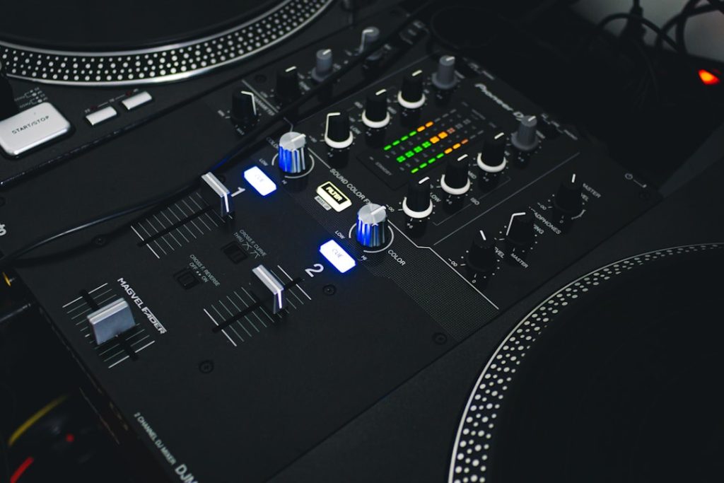 black and gray audio mixer virtual dj interface screen, waveform mixing display, home studio dj setup, laptop dj software