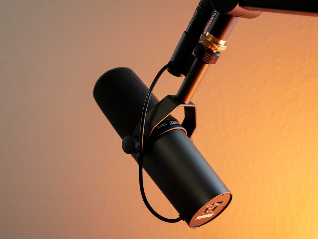 black and silver microphone on brown wall podcast monetization coins microphone earnings concept