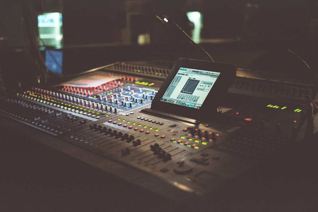 black and white audio mixer digital audio mixing console on screen, multitrack recording session, music producer working