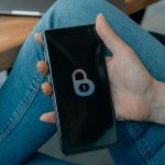 black and white smartphone on persons hand smartphone vpn interface, secure connection screen, mobile cybersecurity