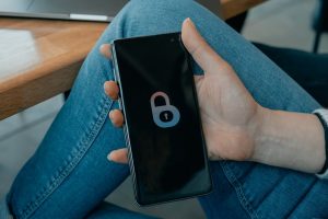 black and white smartphone on persons hand smartphone vpn interface, secure connection screen, mobile cybersecurity