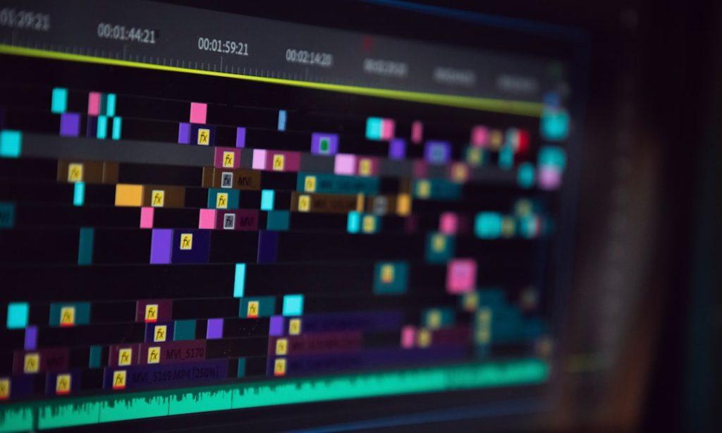 black flat screen tv turned on displaying game audio waveform editing software screen colorful sound waves
