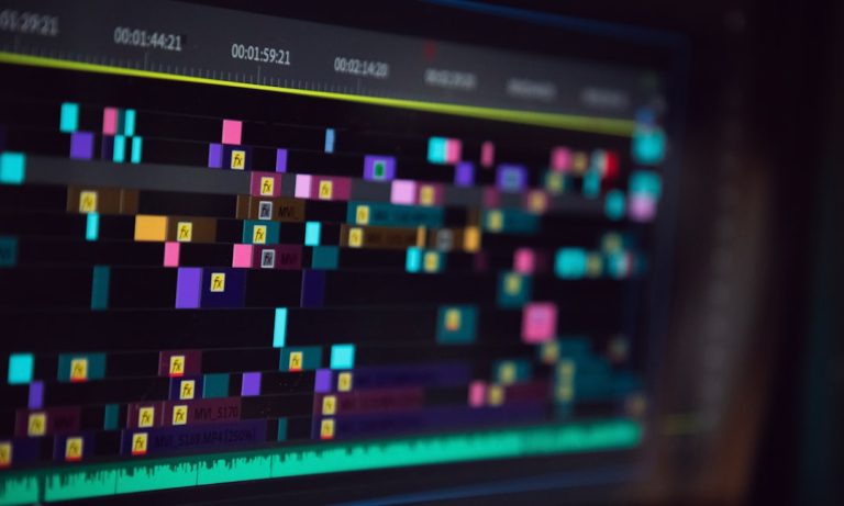 black flat screen tv turned on displaying game audio waveform editing software screen colorful sound waves