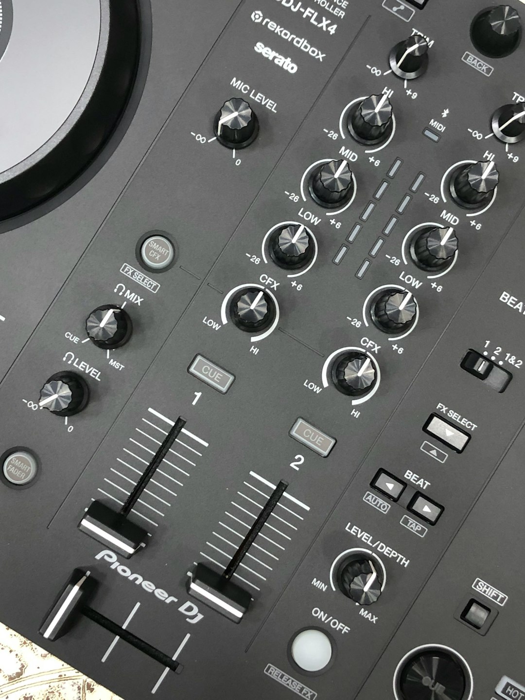 Close-up of a pioneer dj controller with knobs and knobs dj controller close up, rekordbox waveform display, club booth setup, music festival stage