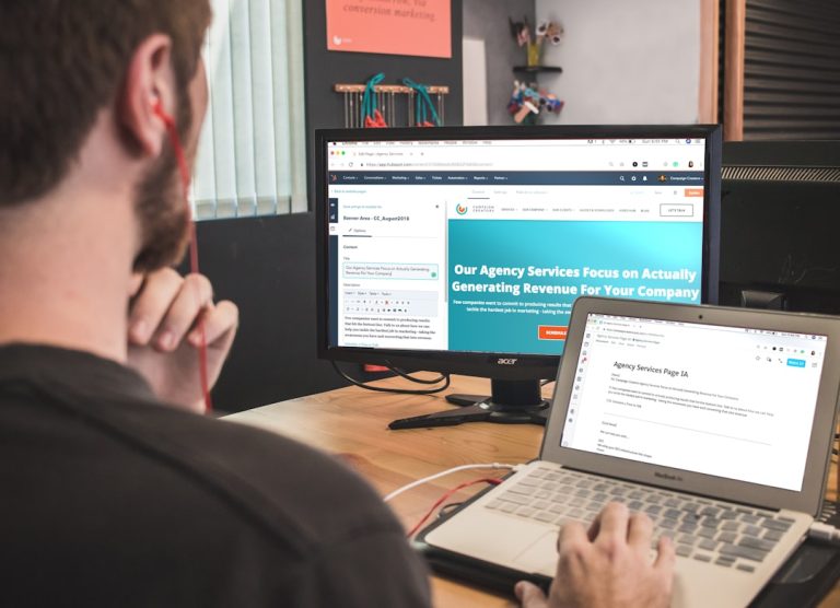 man sitting on chair using silver laptop artificial intelligence writing interface, laptop screen with blog draft, digital content creation workspace