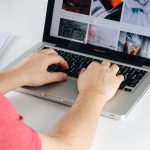 person using MacBook Pro plagiarism report screen, laptop writing desk, content editing software