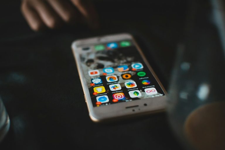 selective focus photography of turned-on gold iPhone 6s music apps comparison, streaming services, desktop icons