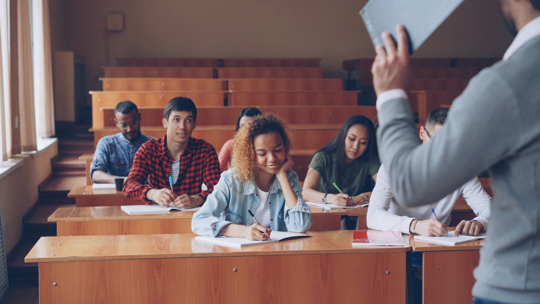 Students listen to a lecture in a classroom. university classroom, academic plagiarism report, research papers stack