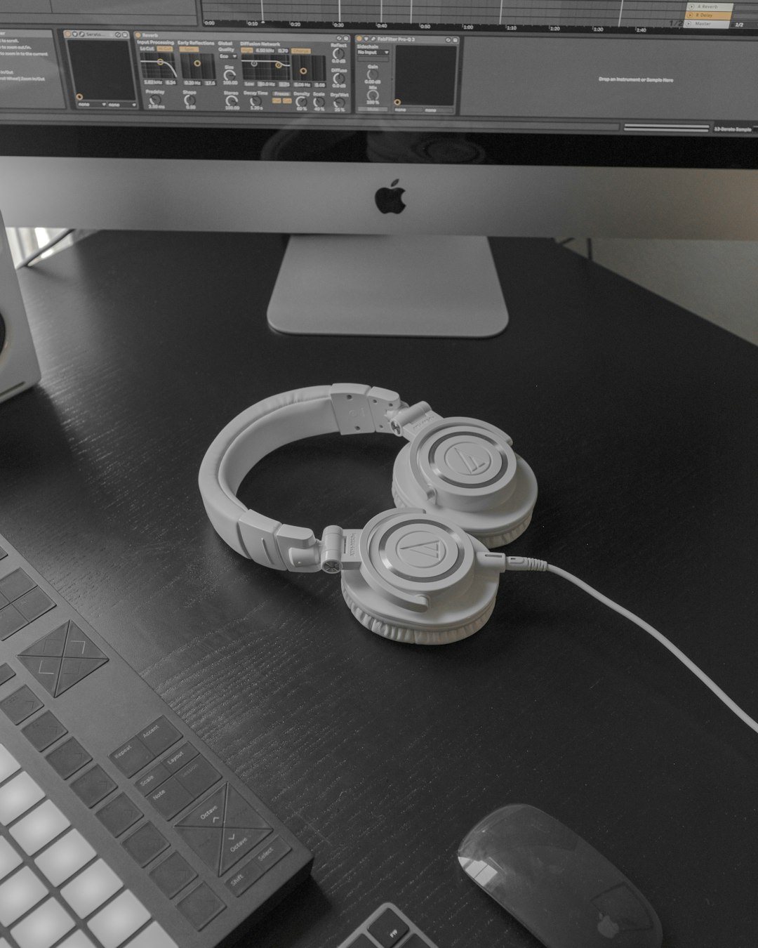 white and black headphones on black table video editor timeline music track layering headphones desk