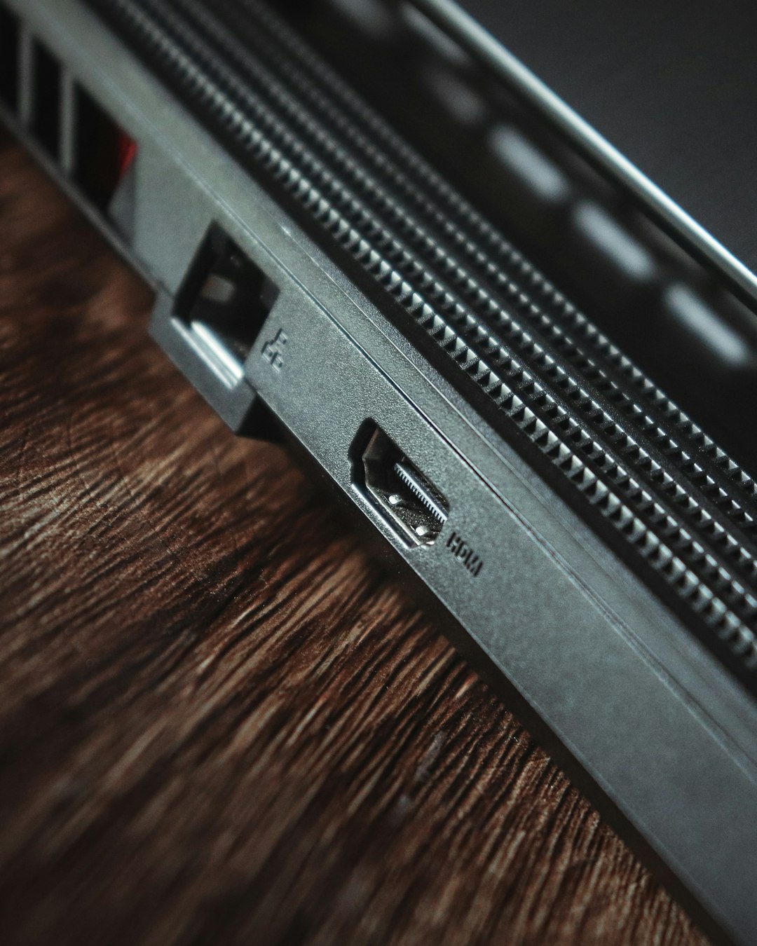 a close up of a laptop on a wooden table cybersecurity dashboard, laptop shield, threat alerts