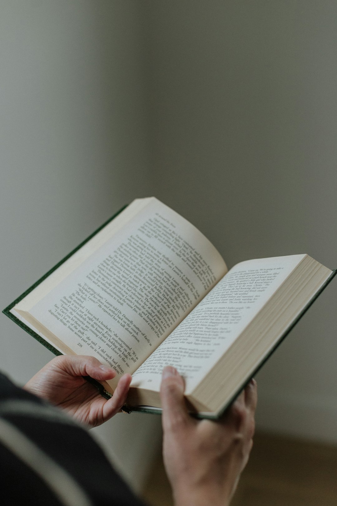 A person holding a book in their hands happy reader, open book, learning progress