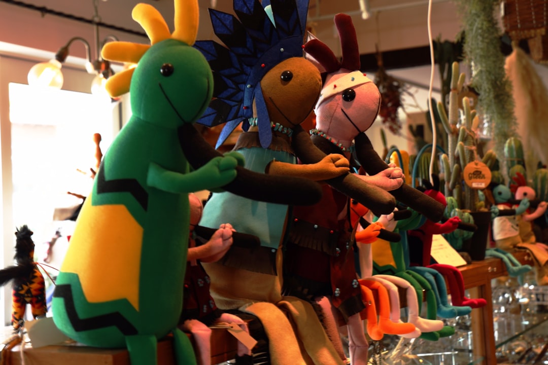 a person in a garment holding a toy horse puppet design, felt characters, colorful materials