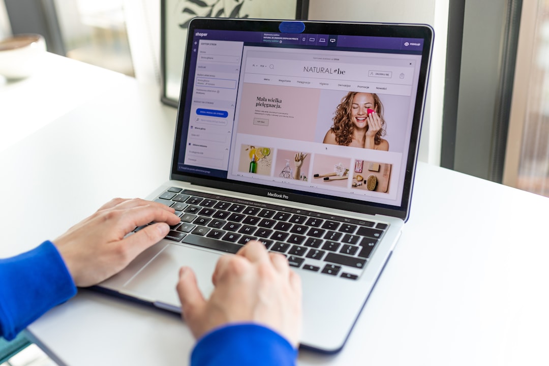 a person using a laptop computer on a table marketing automation, email workflow, ecommerce sales