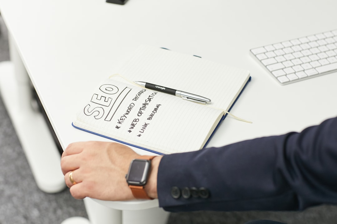 a person writing on a piece of paper url redirects, seo checklist, website planning