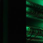 a rack of electronic equipment in a dark room web hosting, server room, website setup