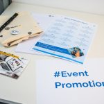 a table with a brochure, magazine, and pen on it event flyers, invitation design, promotional materials
