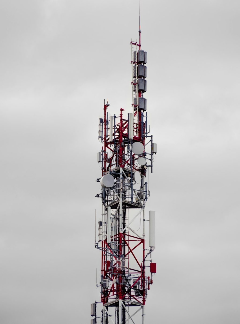 a very tall tower with lots of antennas on top of it emergency dispatch, cloud network, public safety