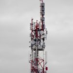 a very tall tower with lots of antennas on top of it emergency dispatch, cloud network, public safety