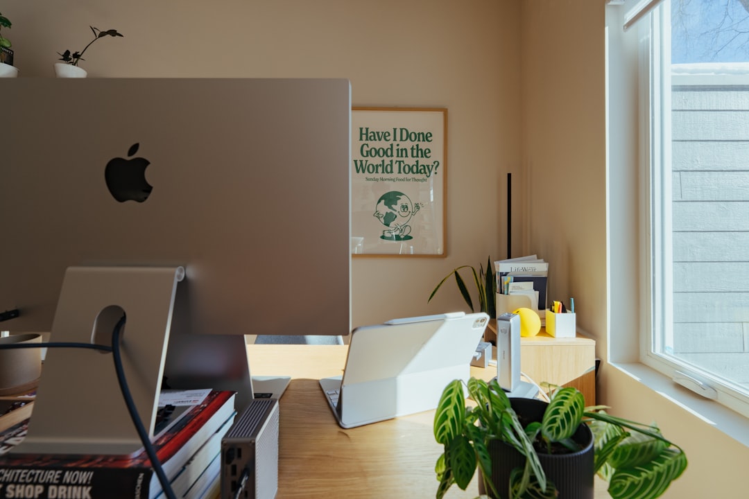 Desk with apple monitor, plants, and window ipad dashboard, calendar widget, productivity setup, modern workspace