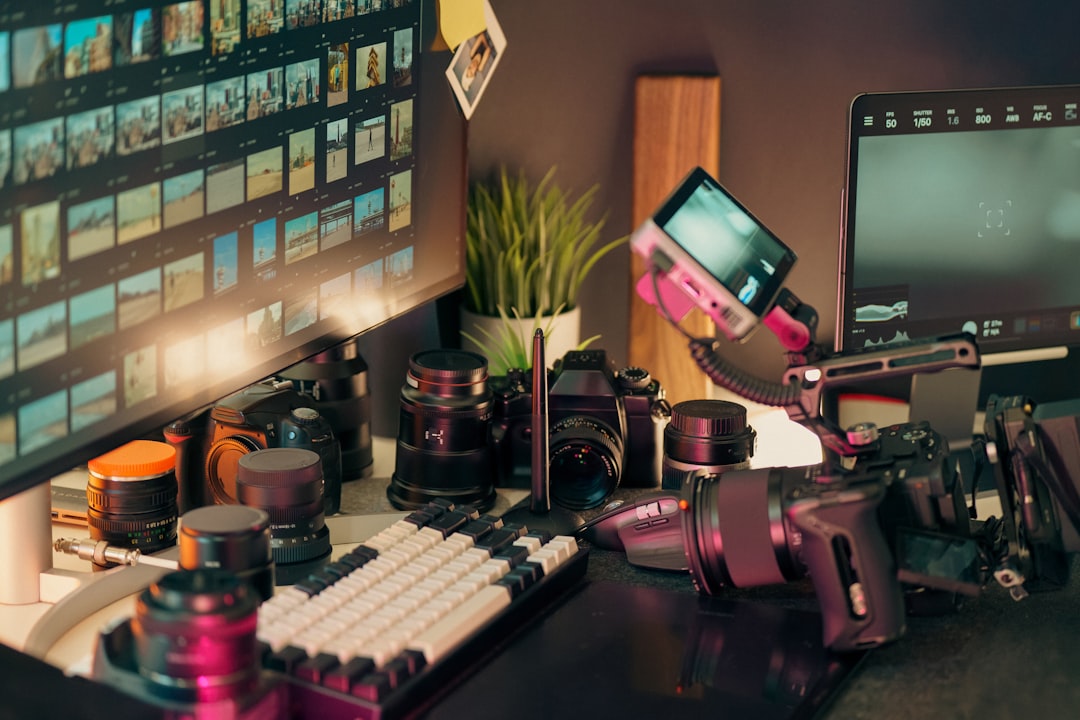 Desk with cameras, lenses, and computer screen. behind the scenes, creative workspace, instagram posts