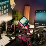 Filmmaker's desk with camera, lenses, and monitors behind the scenes, creative workspace, instagram posts