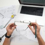 Hands holding glasses over design blueprints cad model, online quote, engineering workspace