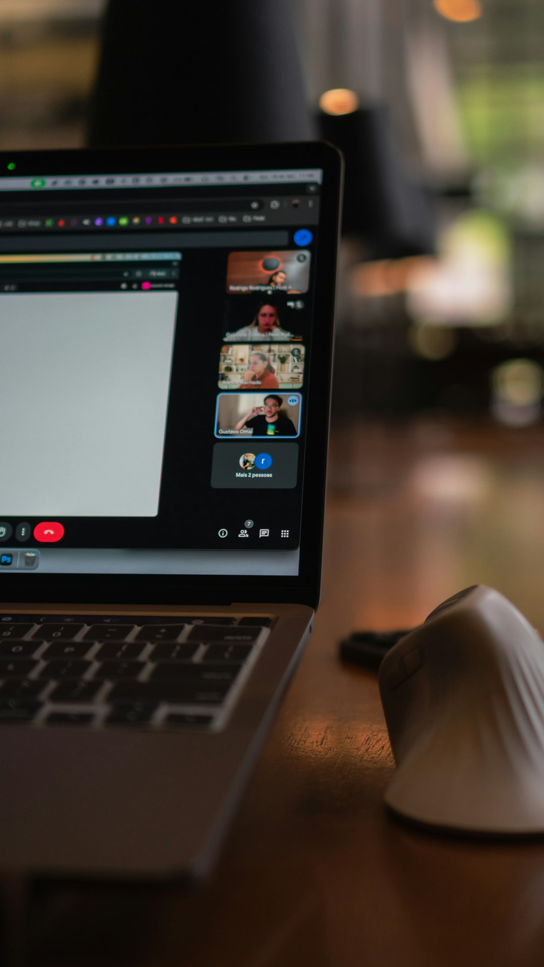 Laptop screen showing a video conference with multiple participants. remote team, chat messages, collaboration workspace