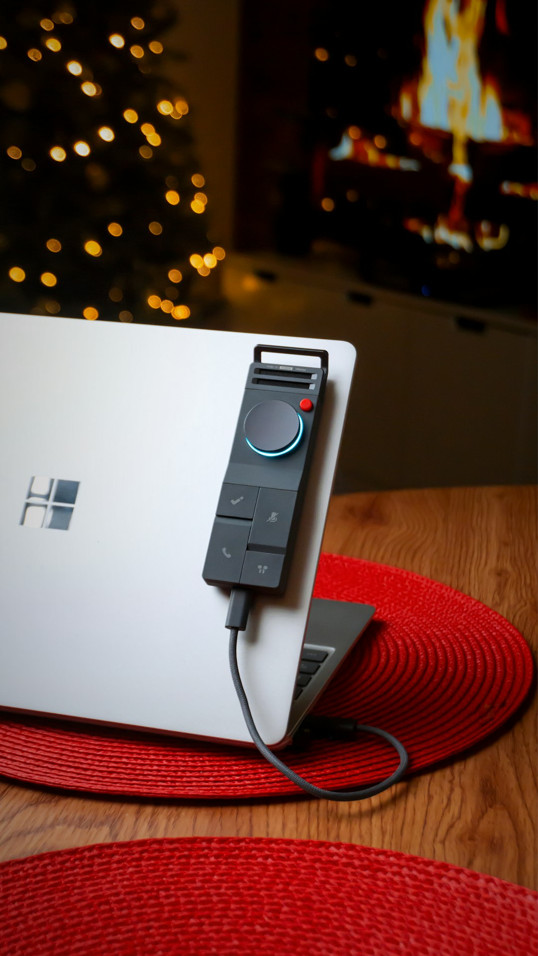 Laptop with a dial controller in a cozy room. surface charger, power adapter, magnetic connector