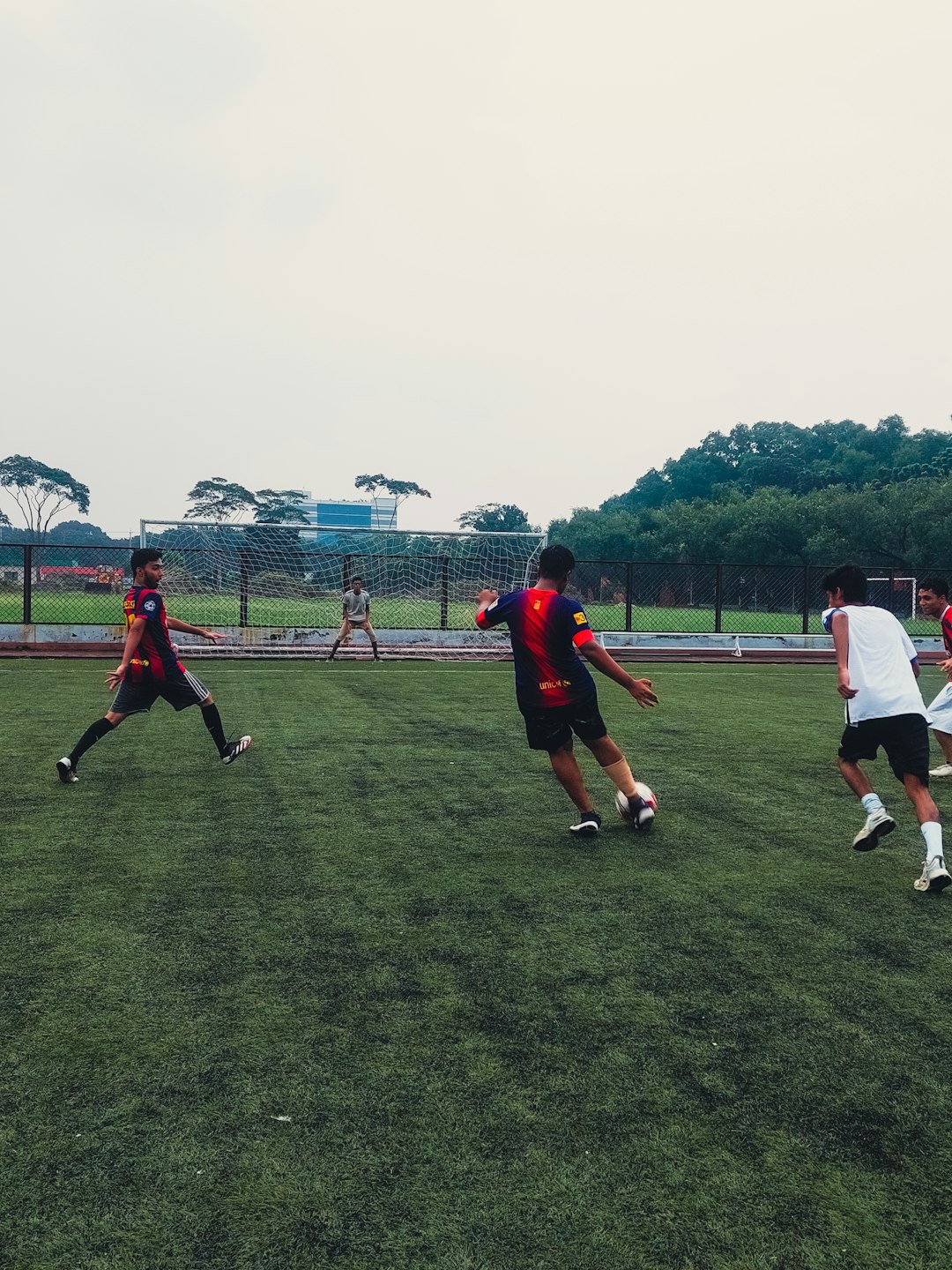 Men playing soccer on a field soccer players, action shot, fierce competition, green field