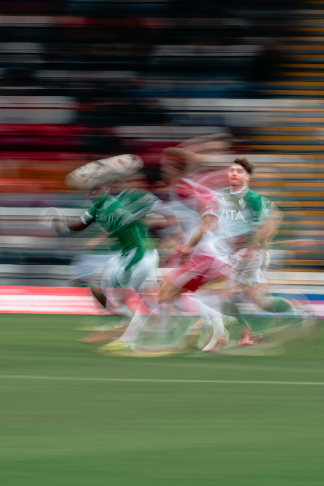 Soccer players in motion on a field soccer players, action shot, fierce competition, green field