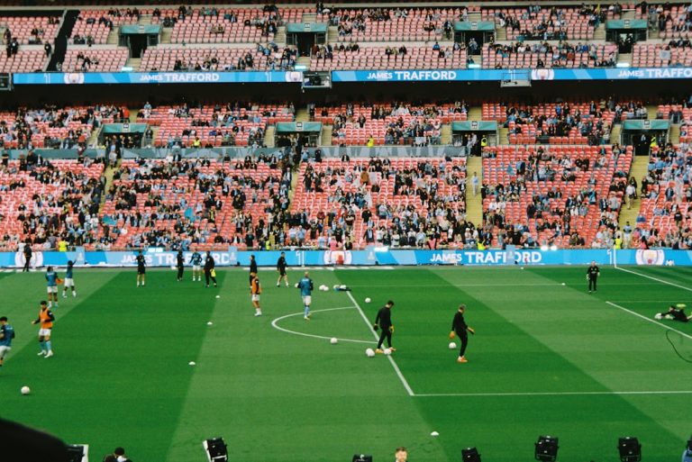 Soccer players warming up on a field in a stadium. soccer team, jerseys, stadium, team spirit