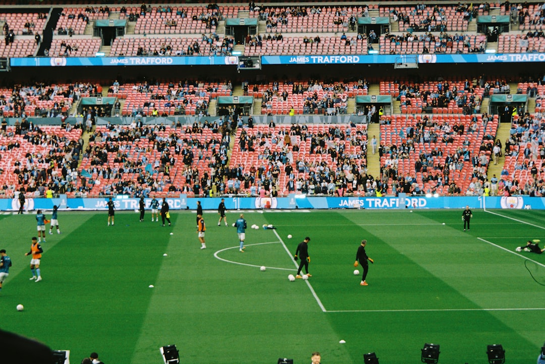Soccer players warming up on a field in a stadium. soccer team, jerseys, stadium, team spirit