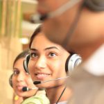 woman in black headphones holding black and silver headphones support team, professional staff, customer care