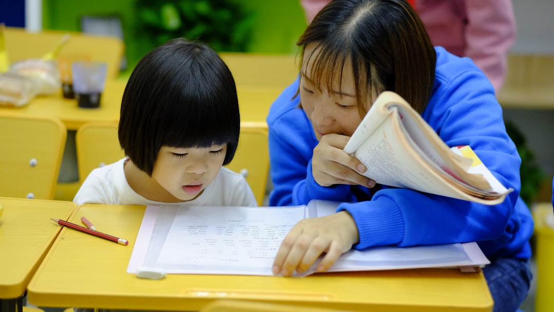 woman teaching girl teacher student reading, vocabulary cards, classroom