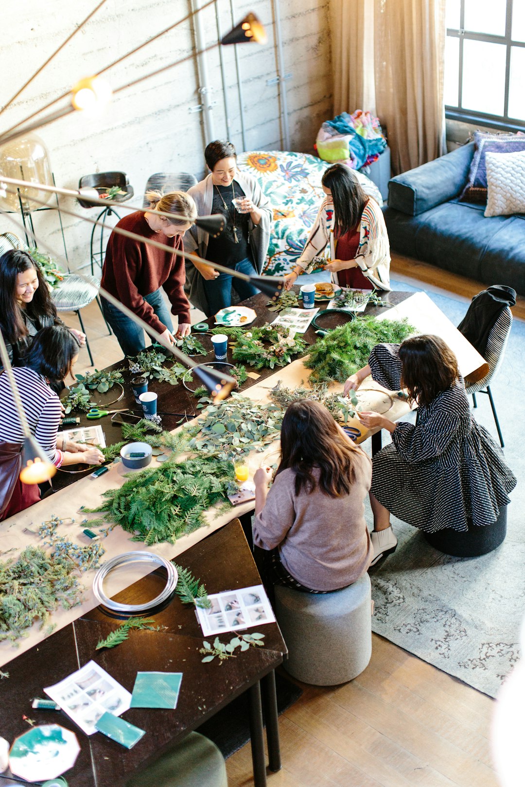 women crafting with greenery at workshop table parenting class, family support, community workshop